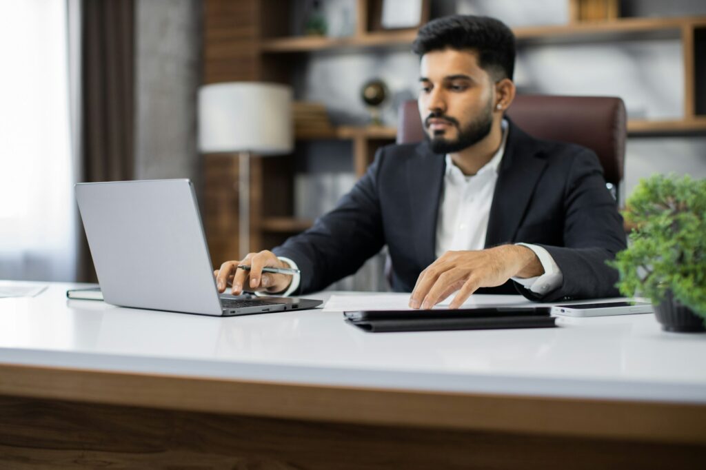 Confident businessman wearing suit writing notes or financial report