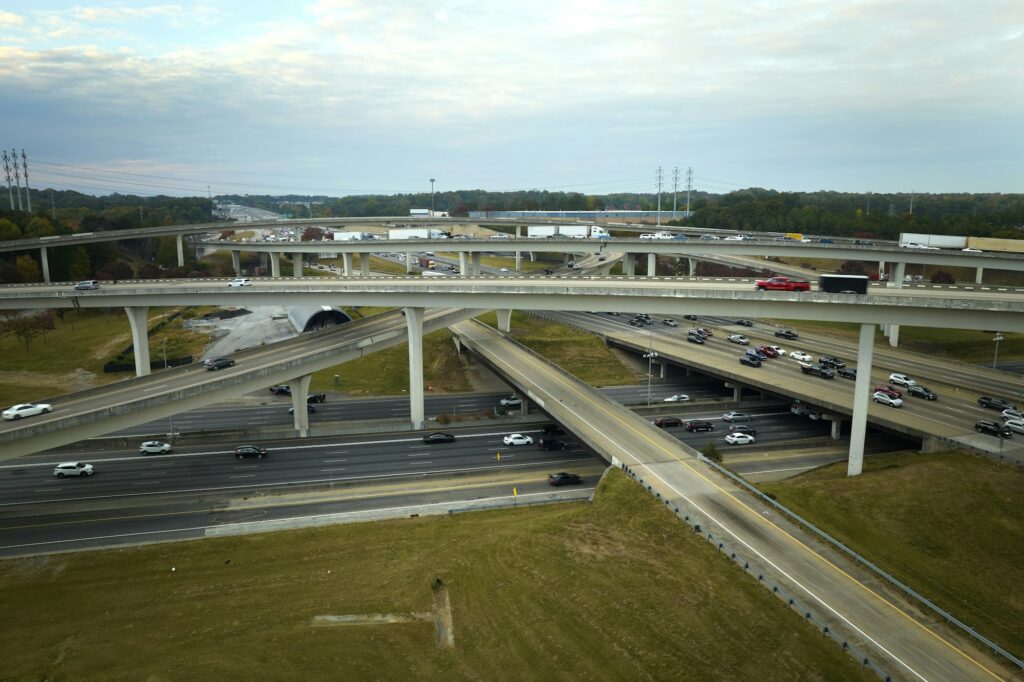 American freeway intersection with fast driving cars and trucks.